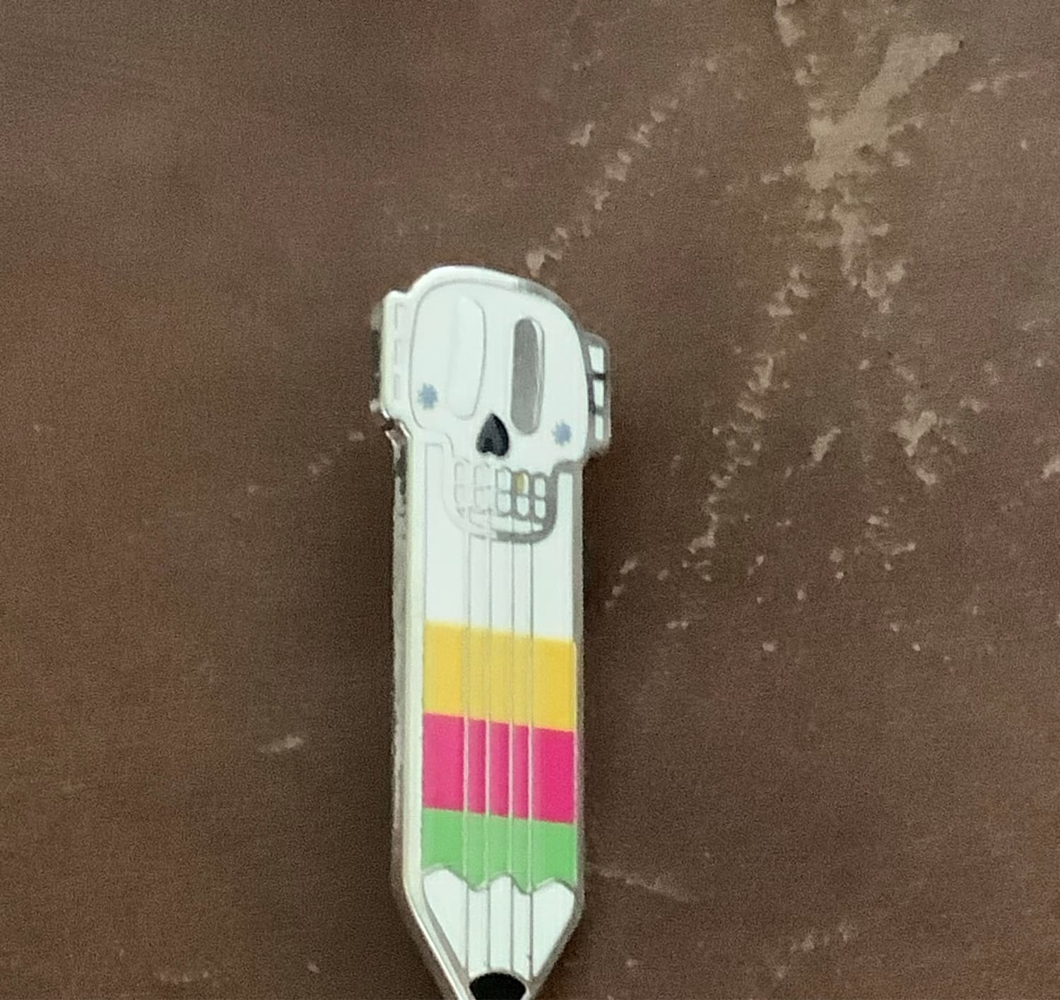 Skull and Pencils Enamel Pin front