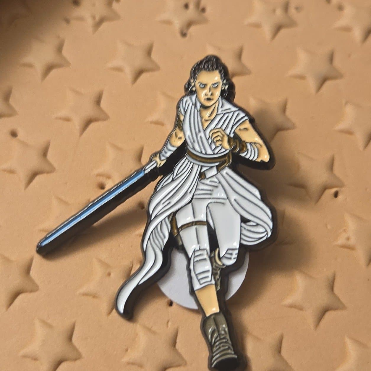 Rey Skywalker Resist Pin with Blue Lightsaber front