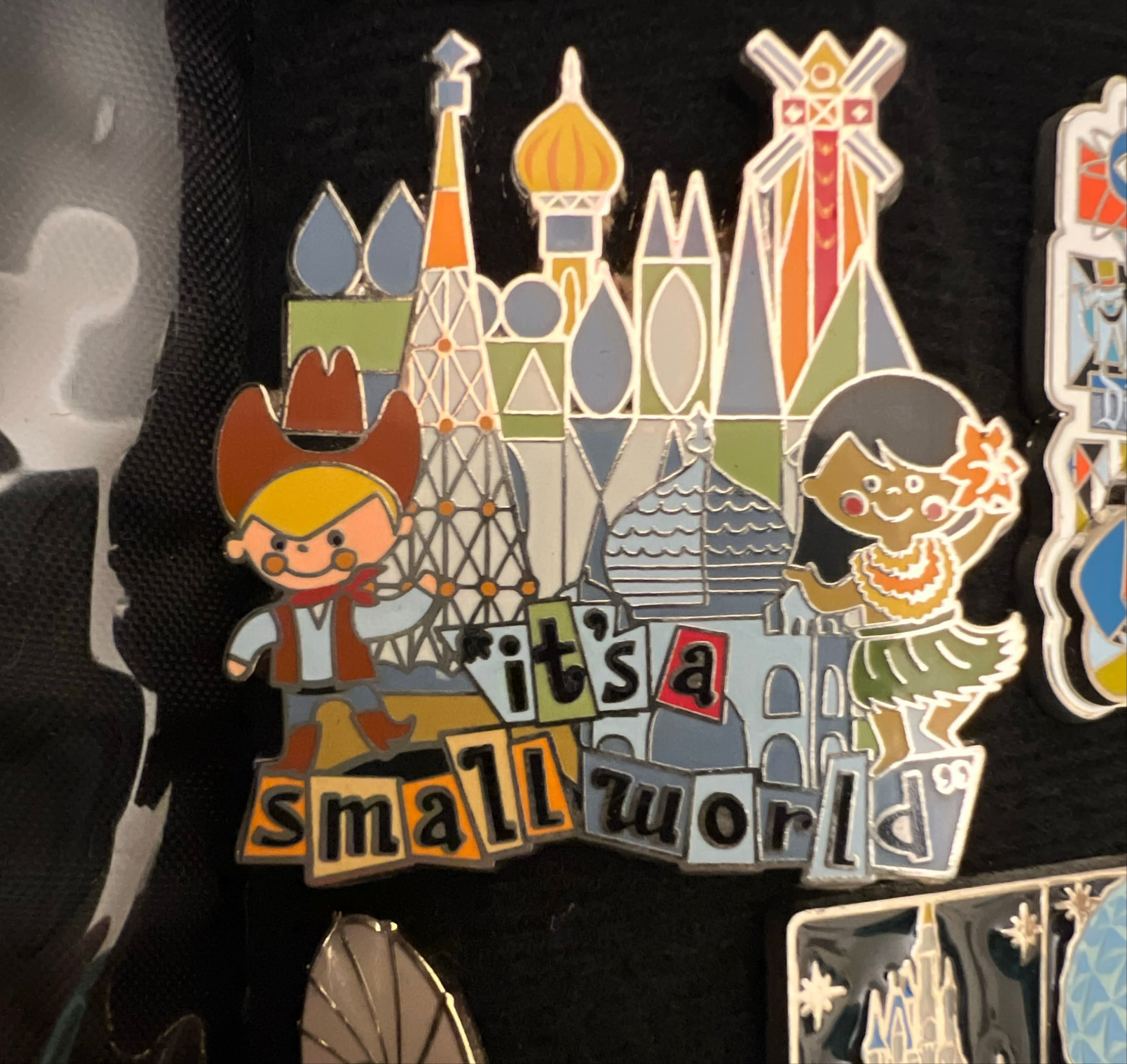 It's a Small World Cowboy and Hula Girl with Buildings Pin front