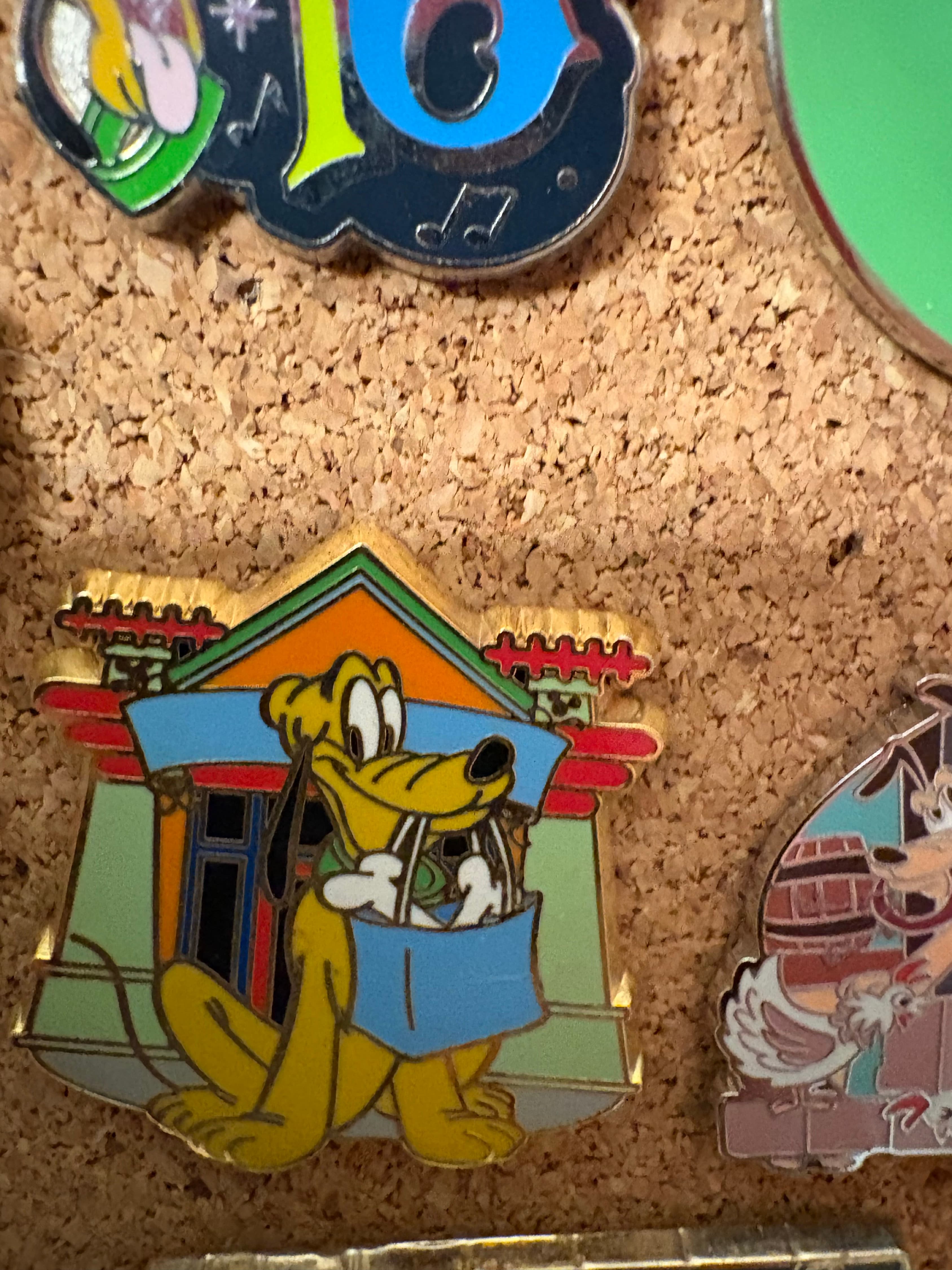 Disney Pluto Pin Outside World of Disney Store Carrying a Bag of Bones front