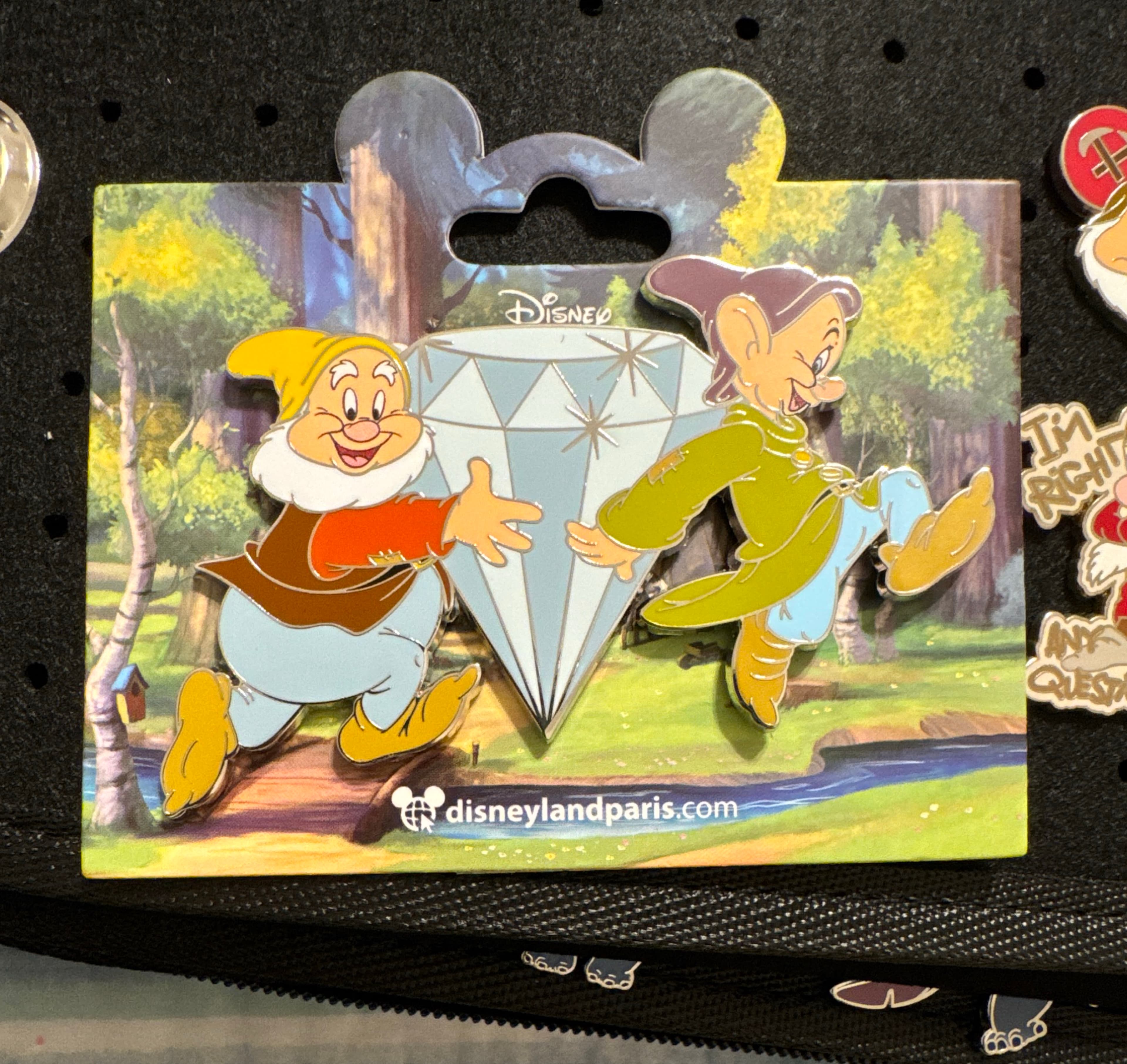 Happy and Dopey holding a big diamond front