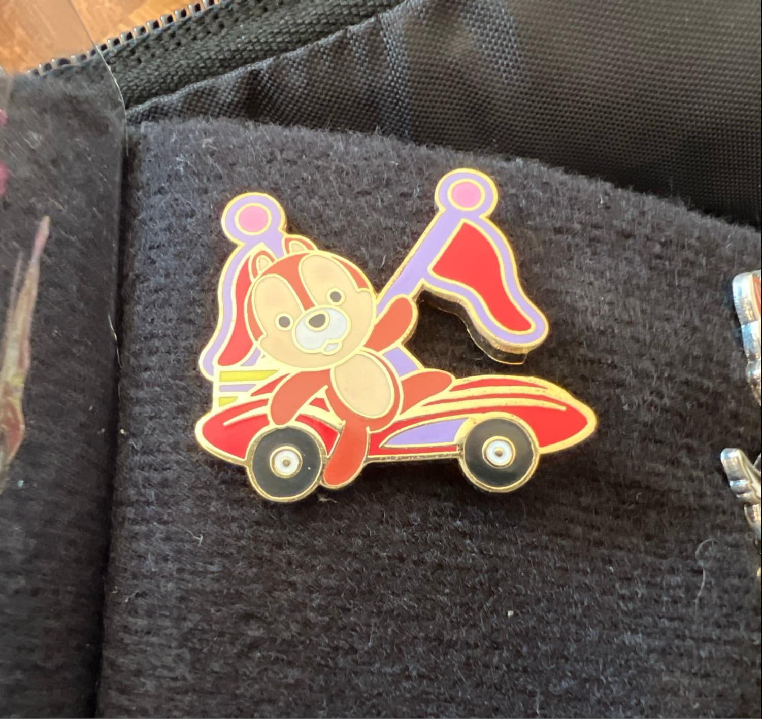 Chip Waving in Red Race Car with Red and Purple Flags front