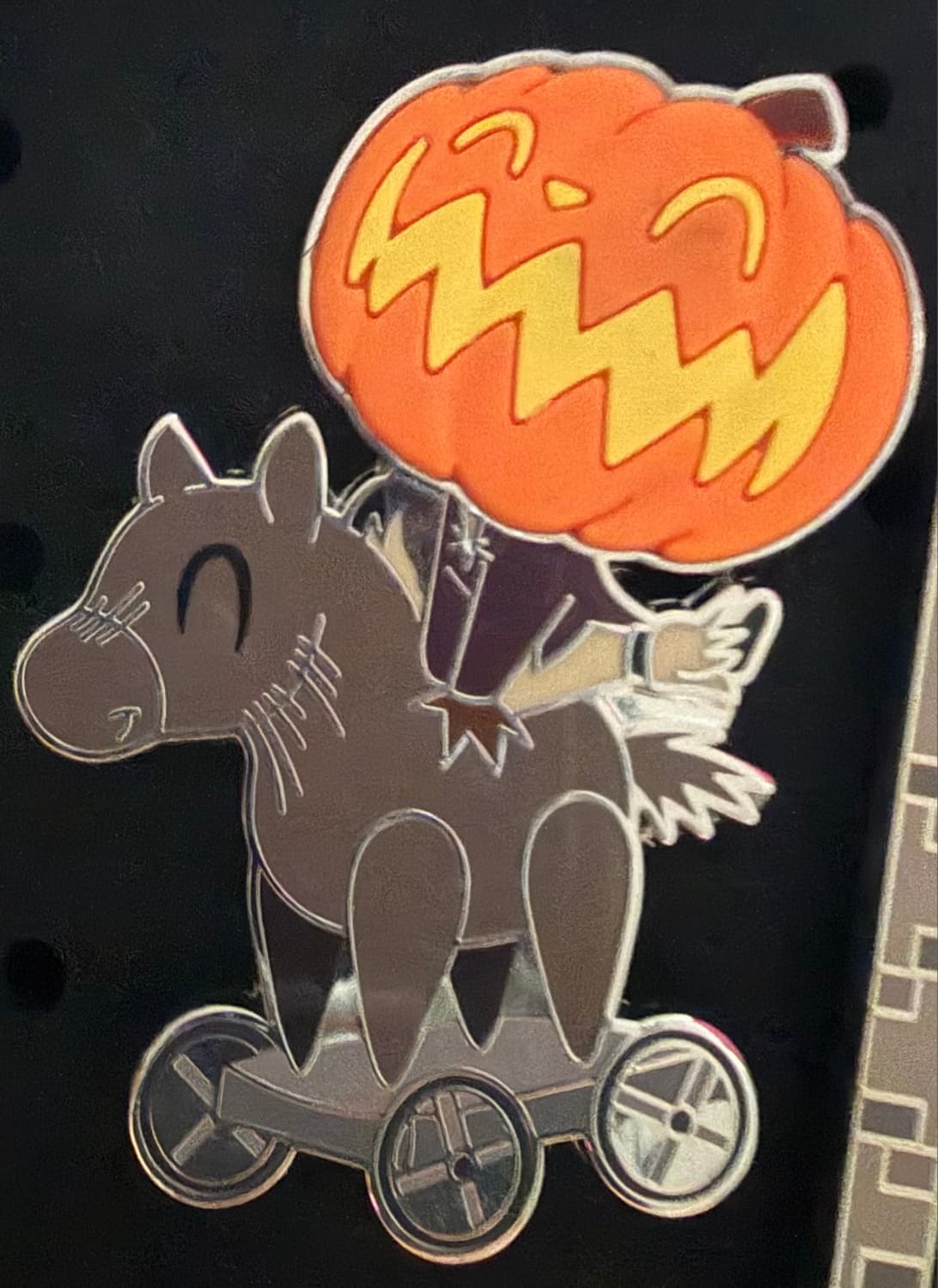 Headless Horseman on Toy Horse Pin front