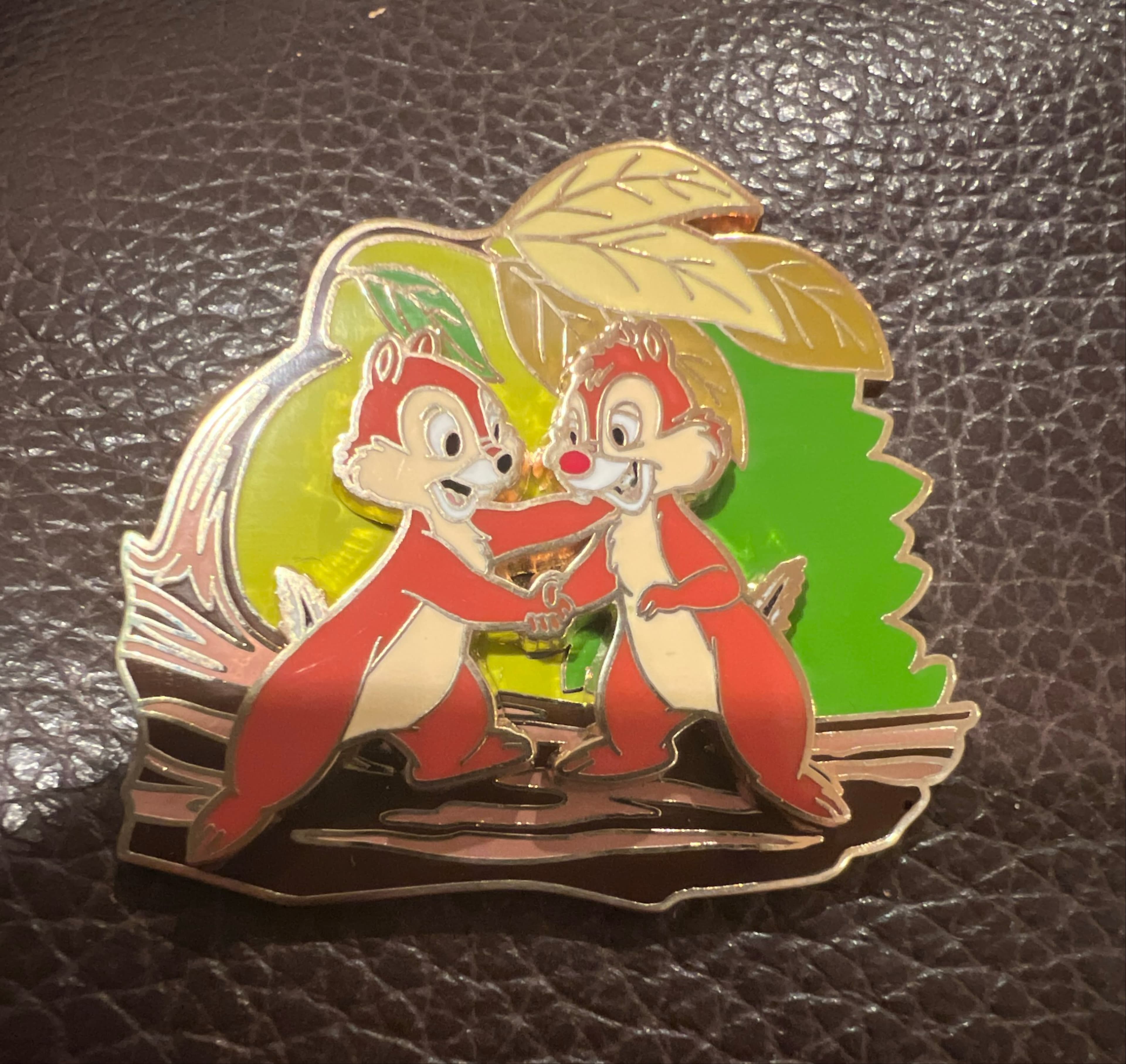 Chip and Dale Shaking Hands on Log with Green Leaf Background front
