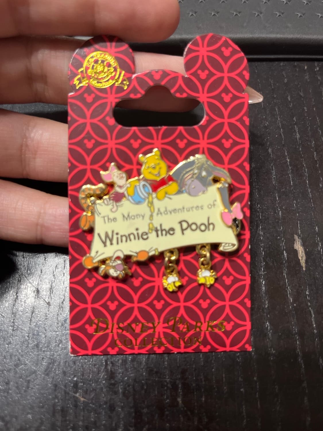 The Many Adventures of Winnie the Pooh Dangle Logo with Bees front