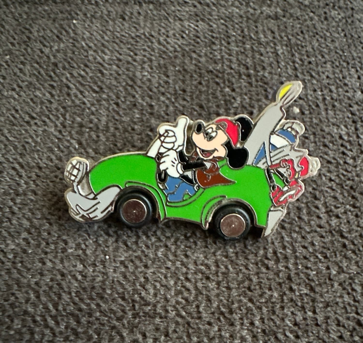 Mickey Mouse in a Packed Green Car With Rubber Wheels front