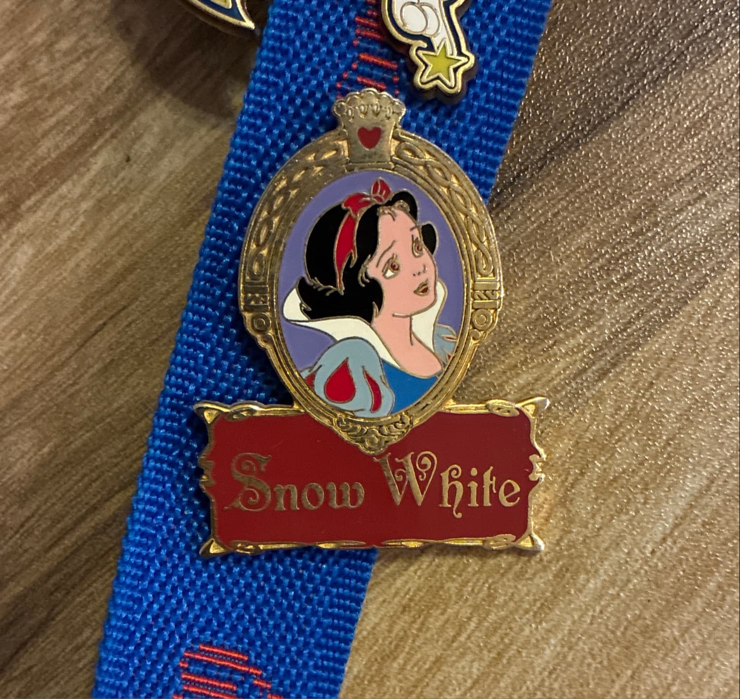 Snow White Portrait in Gold Frame with Red Title Logo Pin front