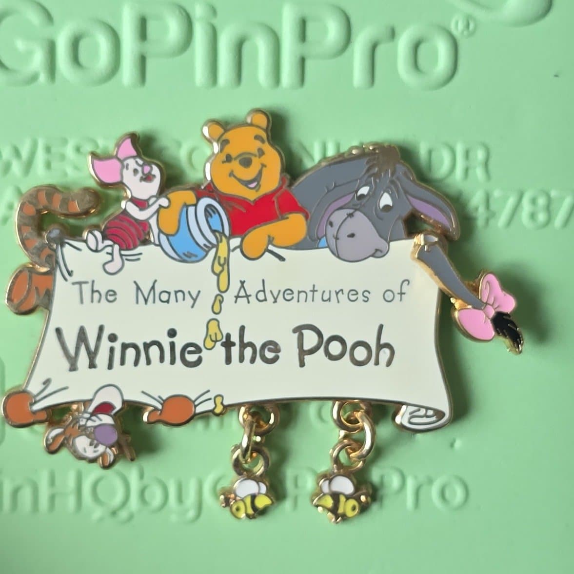 The Many Adventures of Winnie the Pooh Dangle Logo with Bees front