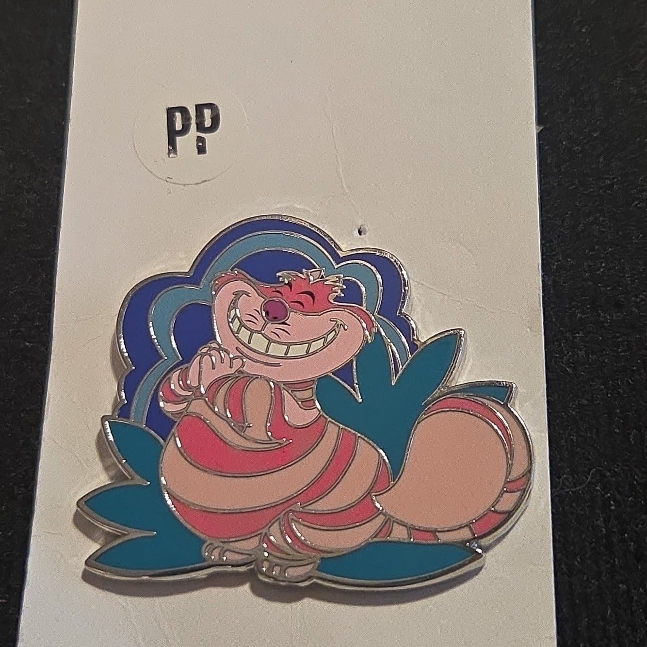 Cheshire Cat Reclining with Blue and Teal Background front