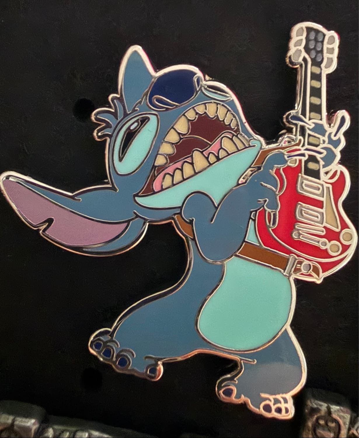 Stitch playing a guitar front