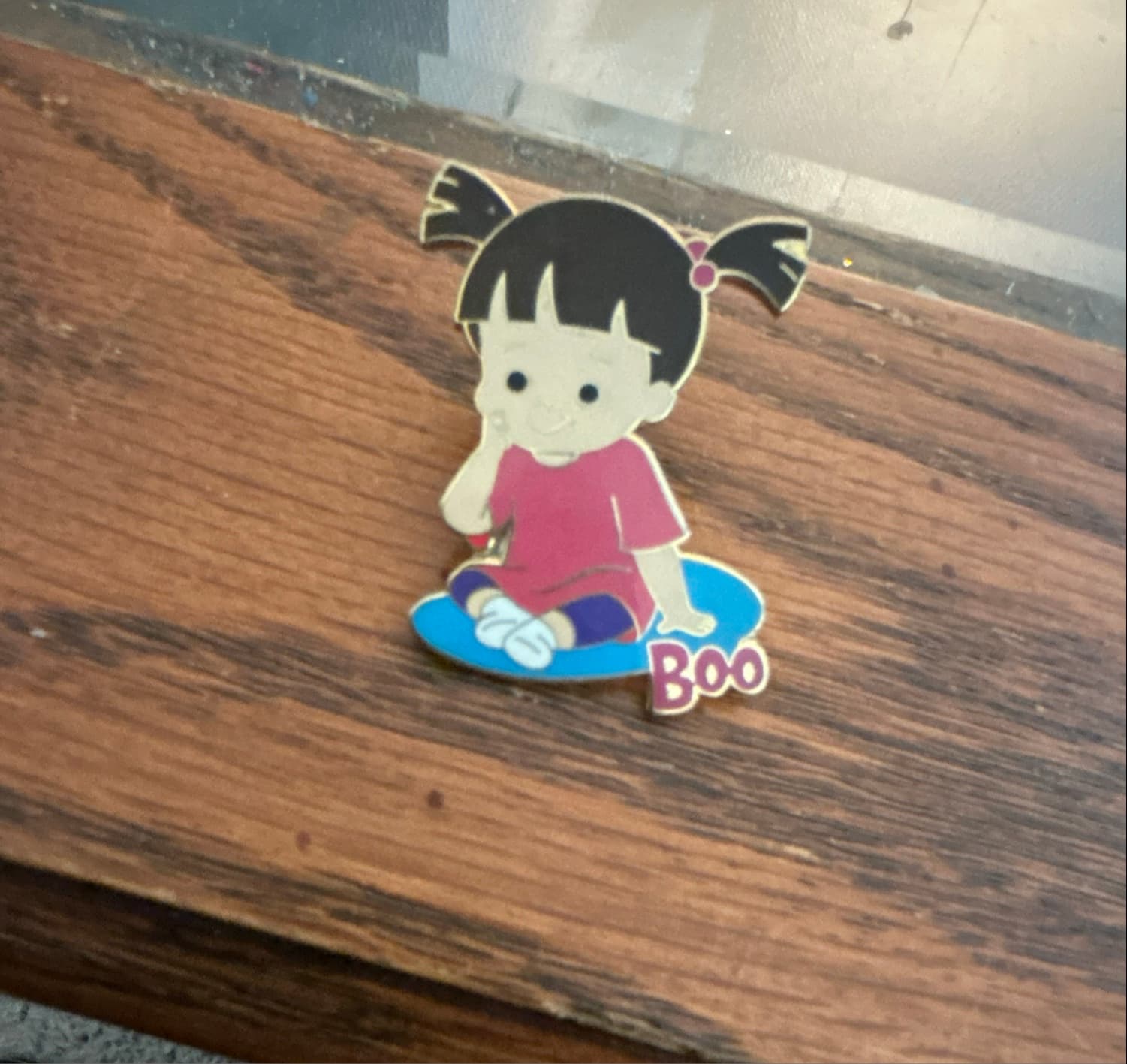 Boo Sitting on Blue Mat with Name - Monsters, Inc. front